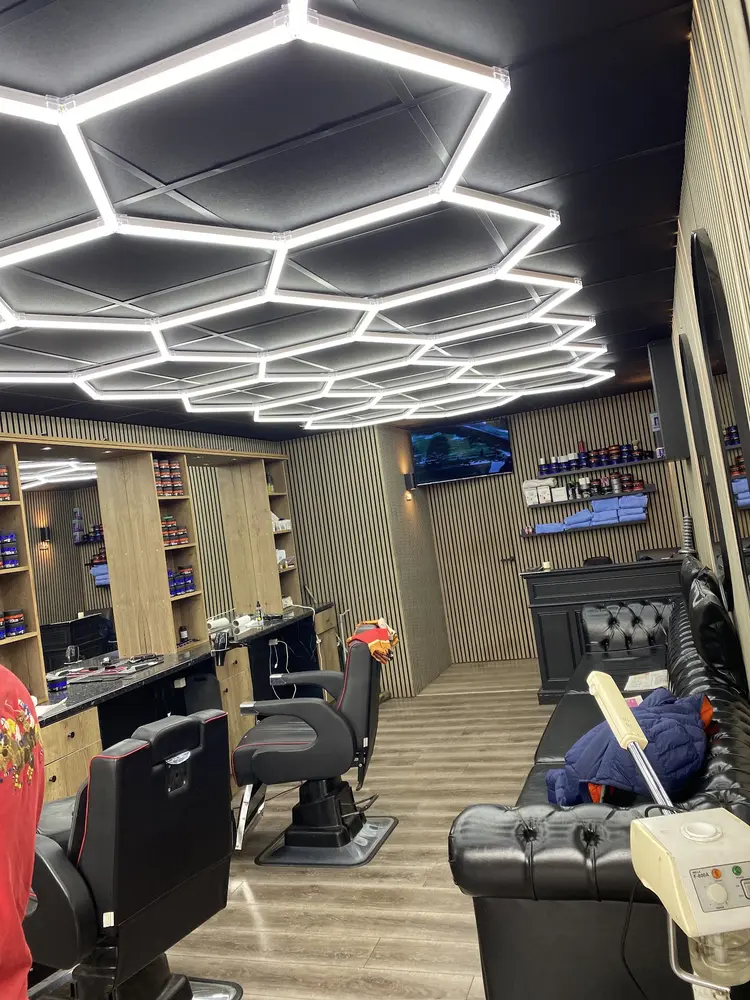 Hex-pattern ceiling above the barber chairs